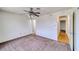 Spacious bedroom features neutral carpet, ceiling fan, and a doorway leading to another room at 2040 Mesquite Ln # 203, Laughlin, NV 89029