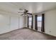 This bedroom features a large closet, neutral carpet, and three windows overlooking the landscape at 2040 Mesquite Ln # 203, Laughlin, NV 89029