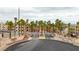 View of gated community entrance surrounded by lush palm trees at 2040 Mesquite Ln # 203, Laughlin, NV 89029