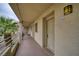 Condo entrance featuring a secure door with outdoor lighting, and palm trees at 2040 Mesquite Ln # 203, Laughlin, NV 89029
