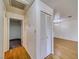 Hallway with vinyl wood-look flooring, a storage closet and doorway that leads to a bedroom with carpeted floors at 2040 Mesquite Ln # 203, Laughlin, NV 89029