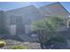 Single-story home featuring desert landscaping, a gated front entry, and a two-car garage at 2048 King Mesa Dr, Henderson, NV 89012