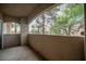 A covered balcony offers outdoor living space with views of mature trees and greenery at 2050 W Warm Springs Rd # 4322, Henderson, NV 89014