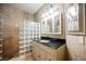 Stylish bathroom features granite counters, updated lighting, tile walls, and a glass-block shower stall at 2050 W Warm Springs Rd # 4322, Henderson, NV 89014