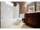 Bathroom features a bathtub with a shower and vanity with traditional-style faucet at 2050 W Warm Springs Rd # 4322, Henderson, NV 89014