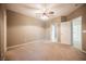Spacious carpeted bedroom features a ceiling fan, neutral walls and two door access points at 2050 W Warm Springs Rd # 4322, Henderson, NV 89014