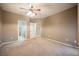 Spacious carpeted bedroom featuring a ceiling fan and two doorways at 2050 W Warm Springs Rd # 4322, Henderson, NV 89014