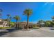 Gated community entrance featuring mature landscaping, desert palms, and covered entrance at 2050 W Warm Springs Rd # 4322, Henderson, NV 89014
