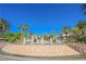 Community water feature fountain with lush desert landscaping and palm trees on a clear, sunny day at 2050 W Warm Springs Rd # 4322, Henderson, NV 89014