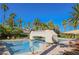 Resort style pool and lounge area surrounded by palm trees creating a luxurious outdoor space at 2050 W Warm Springs Rd # 4322, Henderson, NV 89014