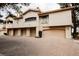 A row of garages in a well maintained stucco building with a paver driveway surrounded by manicured landscaping at 2050 W Warm Springs Rd # 4322, Henderson, NV 89014
