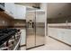 Modern kitchen featuring stainless steel refrigerator, oven, and white cabinets at 2050 W Warm Springs Rd # 4322, Henderson, NV 89014