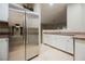 Kitchen with stainless steel refrigerator, neutral countertops, and white cabinets at 2050 W Warm Springs Rd # 4322, Henderson, NV 89014