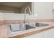 Stainless steel kitchen sink featuring a modern faucet and light speckled countertops at 2050 W Warm Springs Rd # 4322, Henderson, NV 89014