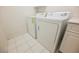 Washer and dryer in laundry room with white tiled floors at 2050 W Warm Springs Rd # 4322, Henderson, NV 89014