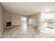 Open-concept living area with tile floors, fireplace, and sliding door access at 2050 W Warm Springs Rd # 4322, Henderson, NV 89014