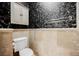 Decorated powder room features travertine tile, wall mounted towel rack, and decorative wallpaper at 2050 W Warm Springs Rd # 4322, Henderson, NV 89014
