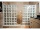 Luxurious shower with glass block partitions and travertine walls; features a handheld sprayer at 2050 W Warm Springs Rd # 4322, Henderson, NV 89014
