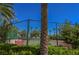 Community tennis courts surrounded by mature landscaping and green shrubbery at 2050 W Warm Springs Rd # 4322, Henderson, NV 89014