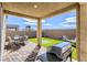 Covered patio with a dining table, BBQ, putting green and mountain views at 2417 Fasano St, Henderson, NV 89044