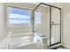 This bright bathroom offers a glass-enclosed shower and views of the Nevada landscape at 2417 Fasano St, Henderson, NV 89044