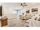 Comfortable living area featuring a sectional sofa, ceiling fan, and neutral decor at 2417 Fasano St, Henderson, NV 89044