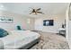 Bright main bedroom includes plush carpeting, a ceiling fan, and ample space for a desk and seating at 2417 Fasano St, Henderson, NV 89044