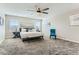 Spacious main bedroom featuring carpeted floors, a ceiling fan, and plenty of natural light at 2417 Fasano St, Henderson, NV 89044