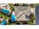 Aerial view of property highlighting tile roof, pool, spa, patio, and lush landscaped backyard at 2440 Ping Dr, Henderson, NV 89074