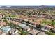 An aerial view of a residential neighborhood with a golf course and desert landscape at 2440 Ping Dr, Henderson, NV 89074