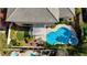 Aerial view showcases pool, spa, patio, artificial turf, lush landscaping, and the home's layout at 2440 Ping Dr, Henderson, NV 89074