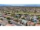An aerial view of a residential neighborhood with lush landscaping and mountain views at 2440 Ping Dr, Henderson, NV 89074