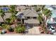 Beautiful aerial view of home showcasing mature landscaping, tile roof, and three-car garage at 2440 Ping Dr, Henderson, NV 89074