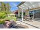 Relaxing backyard space with patio seating, lush landscaping, and a well-maintained lawn at 2440 Ping Dr, Henderson, NV 89074