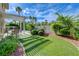 Tranquil backyard featuring artificial turf and mature landscaping, perfect for relaxation and outdoor gatherings at 2440 Ping Dr, Henderson, NV 89074