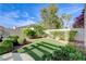 Backyard features artificial turf, mature landscaping and a brick privacy wall at 2440 Ping Dr, Henderson, NV 89074