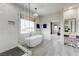 Bright bathroom showcasing a soaking tub, a glass shower, and a vanity area with natural light and modern fixtures at 2440 Ping Dr, Henderson, NV 89074