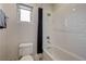 Clean bathroom with white subway tile in shower, dark shower curtain, and patterned tile floor, creating a modern, fresh look at 2440 Ping Dr, Henderson, NV 89074