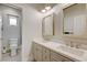 Bright bathroom featuring double sinks, modern fixtures, and decorative tile accents, complemented by stylish mirrors and neutral tones at 2440 Ping Dr, Henderson, NV 89074
