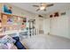 Bright bedroom featuring a desk, cube shelving, and a comfortable couch at 2440 Ping Dr, Henderson, NV 89074