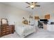 Neutral bedroom with a bed, vintage dresser, and a desk/workstation area with dual monitors at 2440 Ping Dr, Henderson, NV 89074