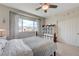 Bright bedroom featuring a bed, large window with patterned curtains, and a closet with sliding doors at 2440 Ping Dr, Henderson, NV 89074