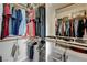 Neatly arranged walk-in closet with built-in shelving and hanging rods for optimized storage at 2440 Ping Dr, Henderson, NV 89074