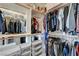 Spacious walk-in closet with custom shelving and clothing racks for organized storage at 2440 Ping Dr, Henderson, NV 89074