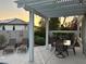Inviting covered patio with outdoor seating, a block wall for privacy, and lush greenery offering a serene outdoor experience at 2440 Ping Dr, Henderson, NV 89074