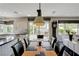Open floorplan view of dining area to backyard with pool and modern kitchen at 2440 Ping Dr, Henderson, NV 89074
