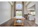 Dining room features a large window, chandelier, hardwood floors, and an open view into the kitchen at 2440 Ping Dr, Henderson, NV 89074