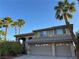Inviting home featuring desert landscaping, a tile roof, and a spacious two-car garage, all bathed in natural light at 2440 Ping Dr, Henderson, NV 89074