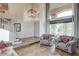 Grand foyer with hardwood floors, staircase, high ceilings, and large window with seating at 2440 Ping Dr, Henderson, NV 89074