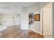 Bright hallway with hardwood flooring leads to an inviting doorway that showcases custom bookshelves, adding charm and character at 2440 Ping Dr, Henderson, NV 89074